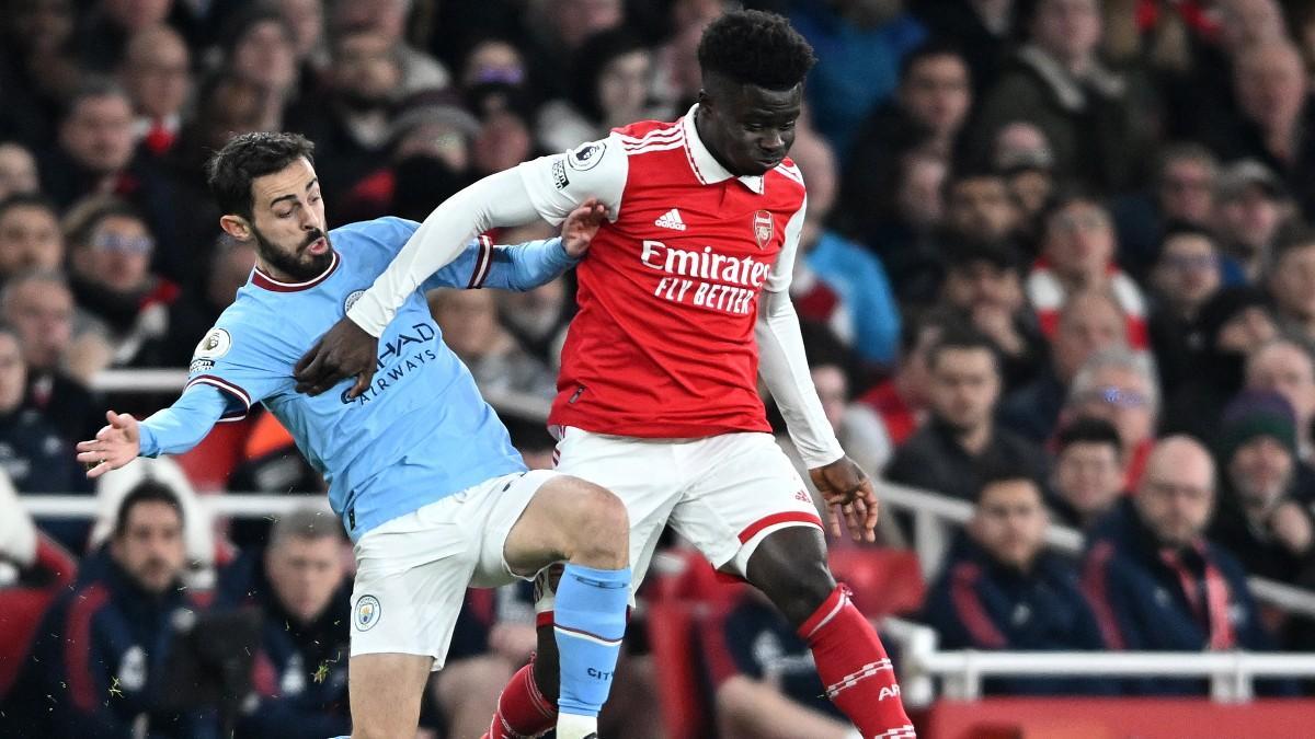 Bernardo Silva pelea un balón con Saka durante el Arsenal-City