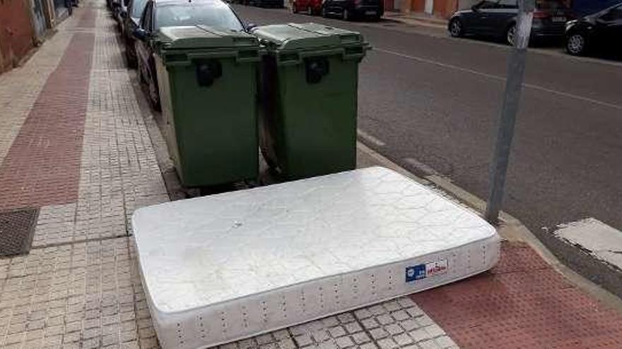 Un colchón tirado junto a dos contenedores en Luis Morán.