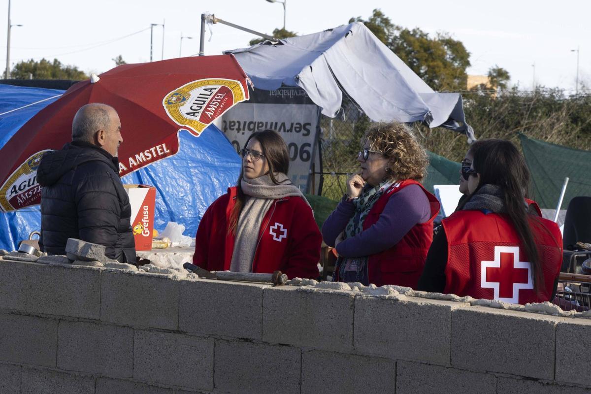 Un equipo de Cruz Roja asiste a una de las personas sin hogar que pernocta en Alzira.