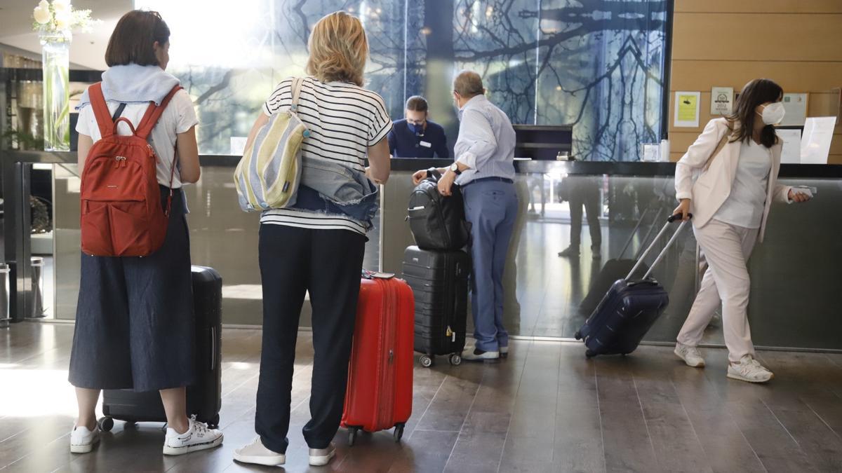 Clientes son atendidos en la recepción de un hotel en Córdoba.