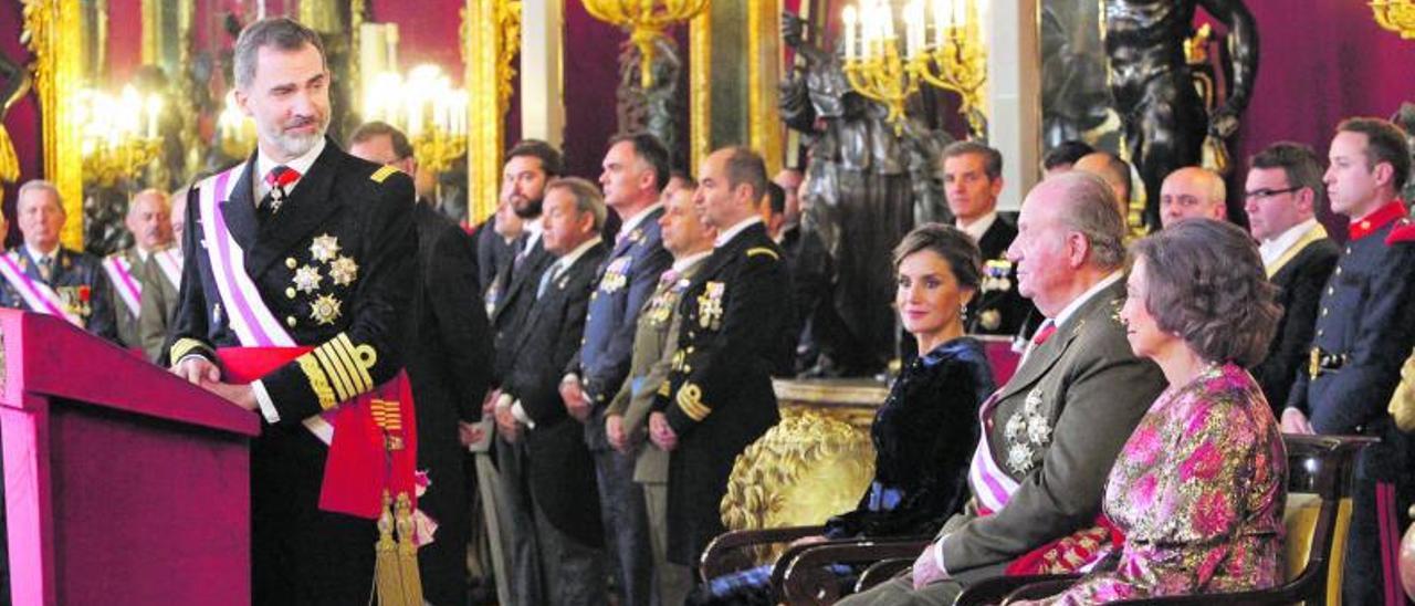 Felipe VI mira a su  padre, el rey emérito Juan Carlos I, en la  Pascua Militar en enero de 2018. (L)