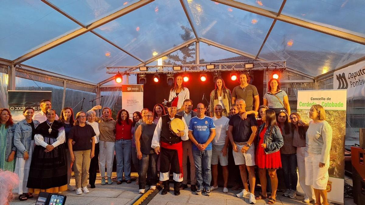 Polo, con la pandereta en la mano, rodeado de familiares, antiguos alumnos y autoridades durante el cierre del homenaje en Carballedo.