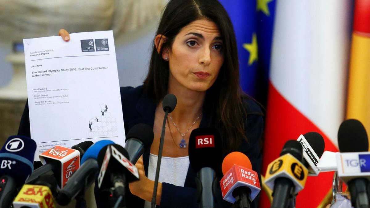 Rome's new mayor Raggi holds a document during a news conference in Rome