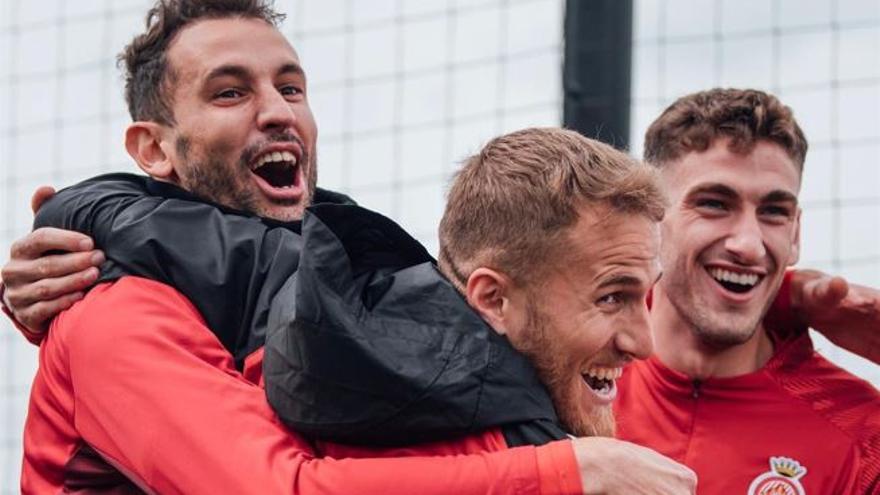 Stuani, Samu Saiz i Santi Bueno somriuen a l&#039;entrenament.