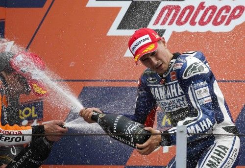Yamaha MotoGP rider Lorenzo sprays champagne at Honda rider Marquez as he celebrates on the podium after winning the San Marino Grand Prix in Misano circuit