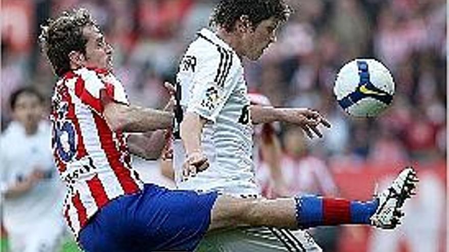 Autet disputa una pilota a Huntelaar en un Sporting-Madrid (08-09).