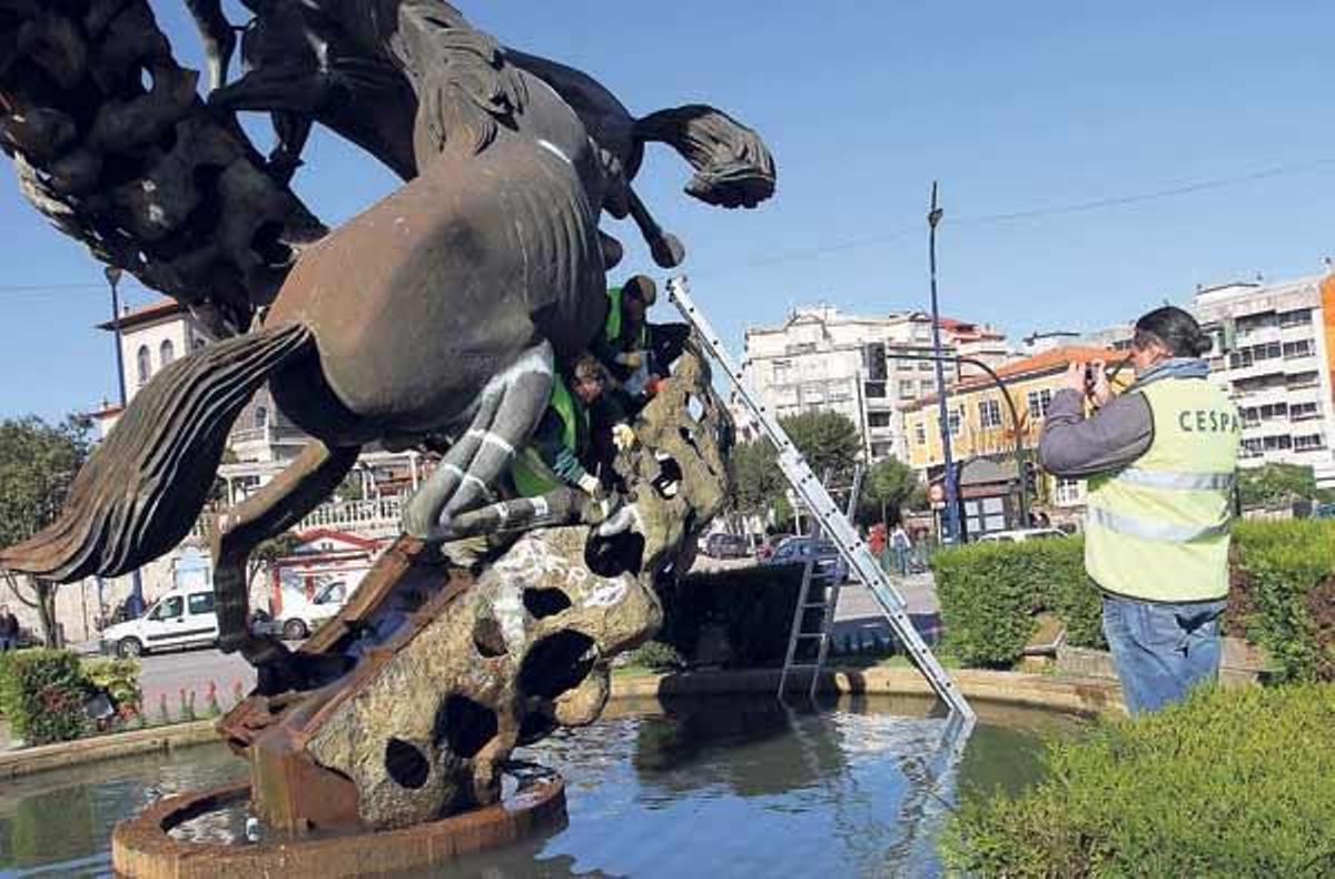 Imagen de unos de los cuatro días que tardó la concesionaria Cespa en limpiar la escultura.  // J. Martínez