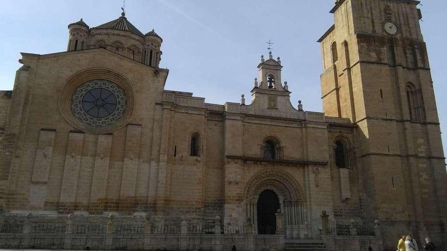 Un grupo de turistas prepara su recorrido ante la portada norte de la Colegiata de Toro.