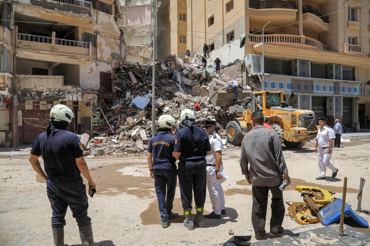 Los socorristas de defensa civil buscan entre los escombros en la escena de un edificio derrumbado de 13 pisos en el distrito de Sidi Bishr de la ciudad de Alejandría, en el norte de Egipto.