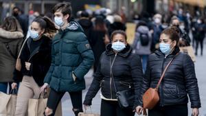 Varias personas hacen sus compras en Madrid, este jueves, con las mascarillas puestas.