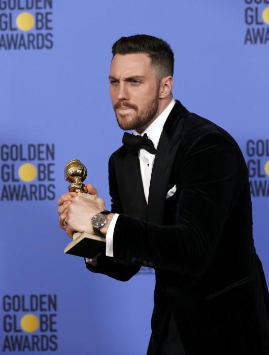 Aaron Taylor-Johnson holds his award during the ...