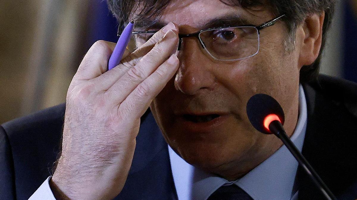 Catalan separatist leader Carles Puigdemont attends a news conference in Alghero