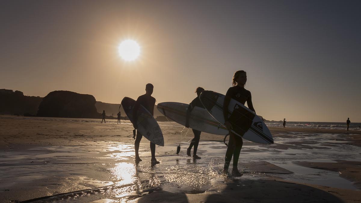 Surferos en la playa de Penarronda