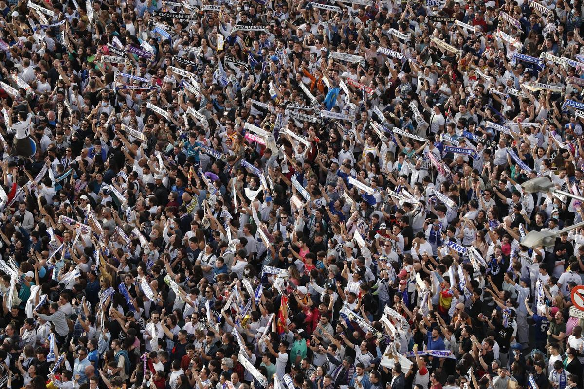 MADRID, 30/04/2022.- Aficionados del Real Madrid en la plaza de Cibeles de Madrid, esperan la llegada de los jugadores para celebrar el título de Liga conseguido por el equipo tras vencer al RCD Espanyol por 4-0, en el partido de Liga disputado este sábado en el estadio Santiago Bernabéu, en Madrid. EFE/JUAN CARLOS HIDALGO