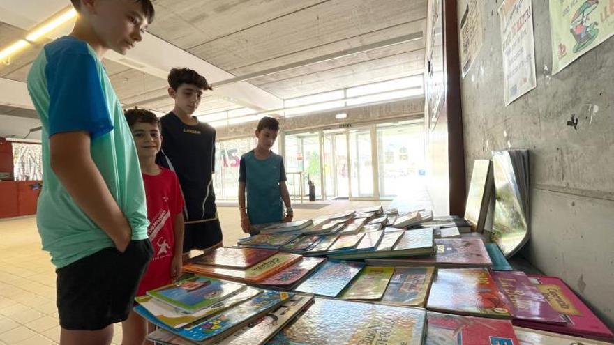 Un grupo de niños, ante varios de los libros que se ofrecen. | C. M. B.