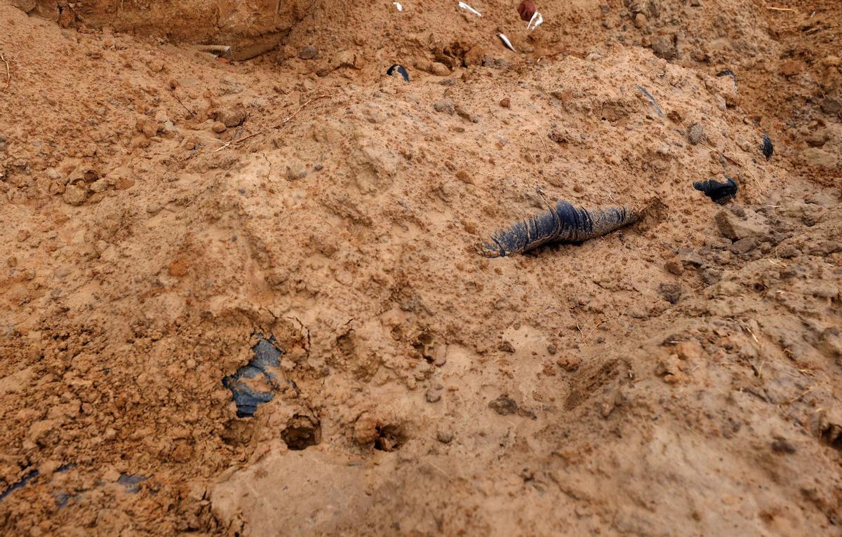 Bodies of civilians, who according to residents were killed by Russian army soldiers and then buried along with others in one grave, are seen, amid Russias invasion of Ukraine, in Bucha