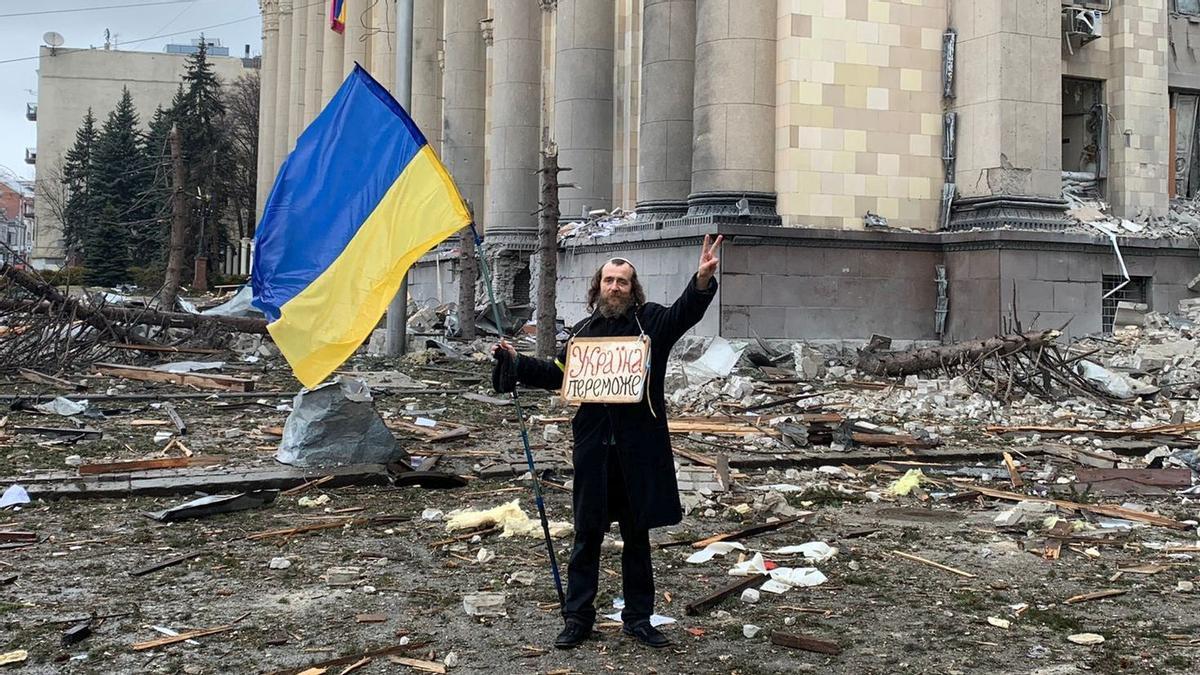 2 de marzo del 2022. JARKOV. UCRANIA. un judio de Jarkov enarbola desafiante una bandera ucraniana frente a la sede de la Administración Regional, destruida por un bombardeo ruso. FOTOS EN LA PLAZA DE LA LIBERTAD DE JARKOV. FOTO DE MARC MARGINEDAS