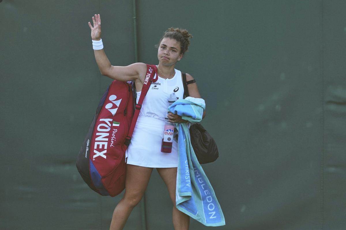 Jasmine Paolini of Italy waves as she leaves the court after losing to Russia's Kamilla Rakhimova during their second round women's singles match at the Wimbledon Tennis Championships in London, Wednesday, July 2, 2025. (AP Photo/Joanna Chan)