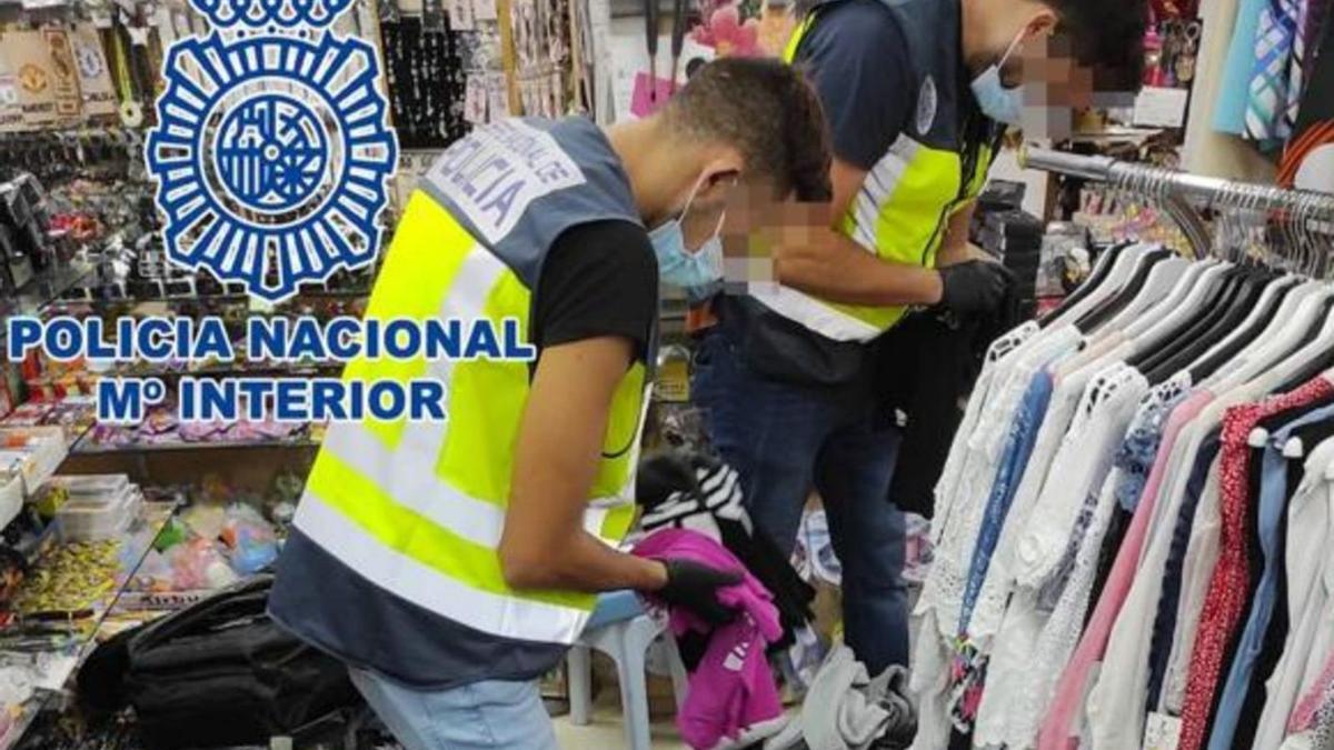 Dos agentes de la Policía Nacional, con artículos falsificados en un local en el sur de Tenerife. | | LP / DLP