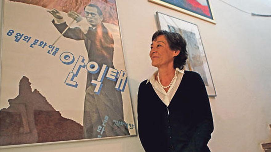 La hija pequeña del músico posa en su casa de Son Matet junto a un poster en el que aparece su padre, el maestro Eaktay Ahn.