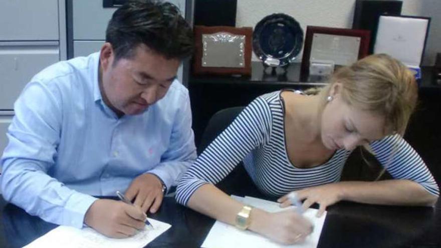 Kazunori Nanao, presidente de Ramzes, y Laura Ortiz firman el convenio.