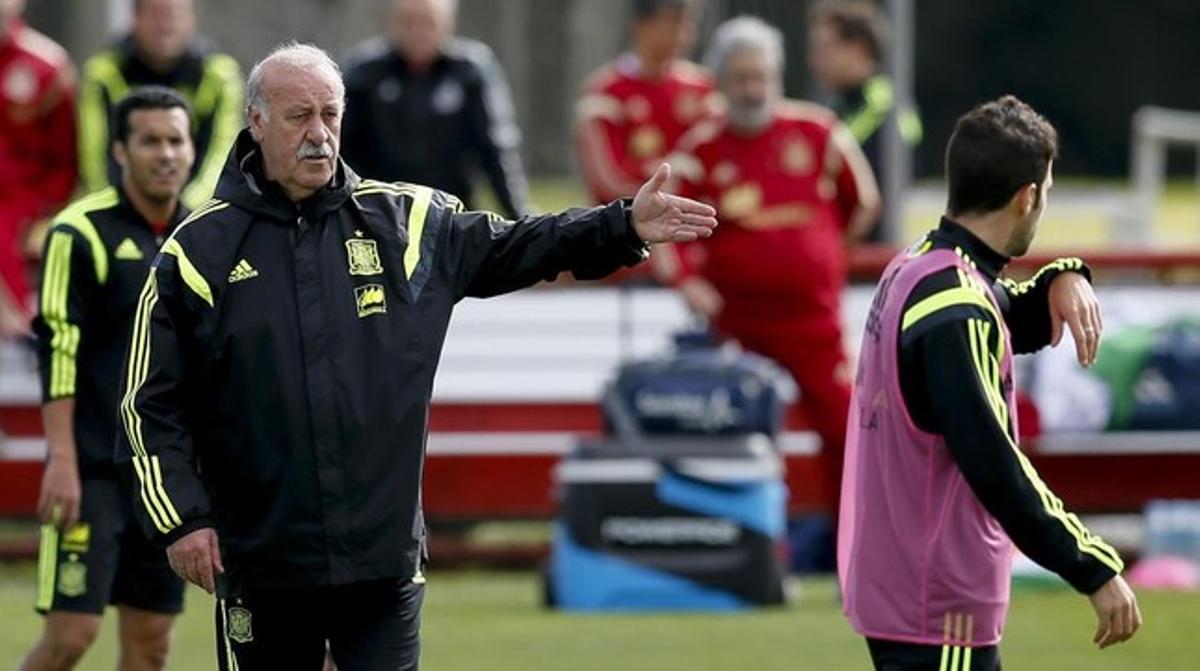 Del Bosque insta Cesc a treure’s el peto de titular i donar-l’hi a Xabi Alonso durant l’entrenament d’aquest dissabte a Curitiba.