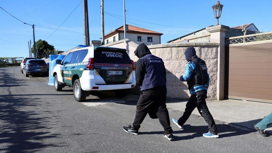 Dos profesionales de Vigilancia Aduanera, en el registro que tuvo lugar en Ribadumia. |   // NOE PARGA