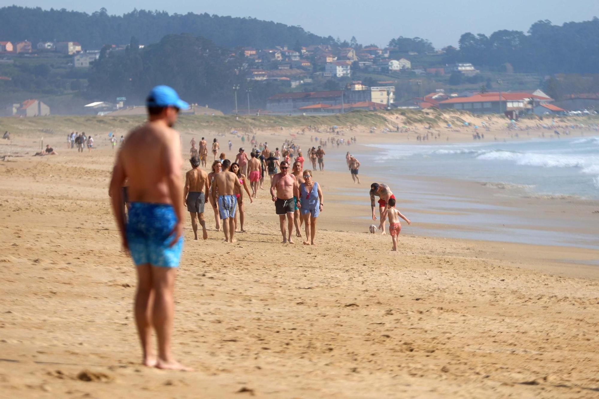 Arousanos y turistas disfrutan en las playas de un anticipio del verano.