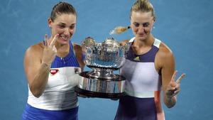 Tennis - Australian Open - Women’s Doubles Final - Melbourne Park, Melbourne, Australia - January 31, 2020  Hungary’s Timea Babos and France’s Kristina Mladenovic celebrate with the trophy after winning the final against Taiwan’s Su-Wei Hsieh and Czech Republic’s Barbora Strycova. REUTERS/Edgar Su