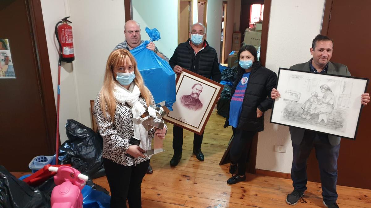 La presidenta de la Favec, María Pérez, junto a otros miembros de la asociación recogiendo los enseres del local de Praza da Princesa