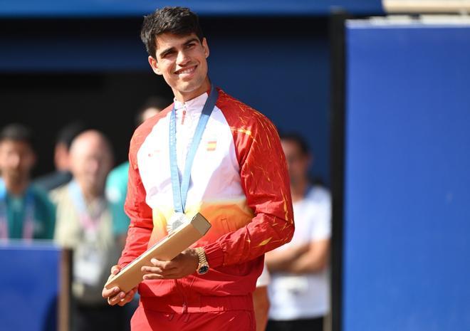 Carlos Alcaraz posa con la medalla de plata tras la final individual masculina de tenis de los Juegos Olímpicos de París 2024.