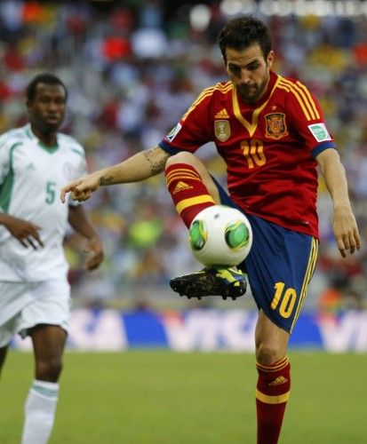 Spain's Fabregas controls the ball near Nigeria's Ambrose during their Confederations Cup Group B soccer match at the Estadio Castelao in Fortaleza
