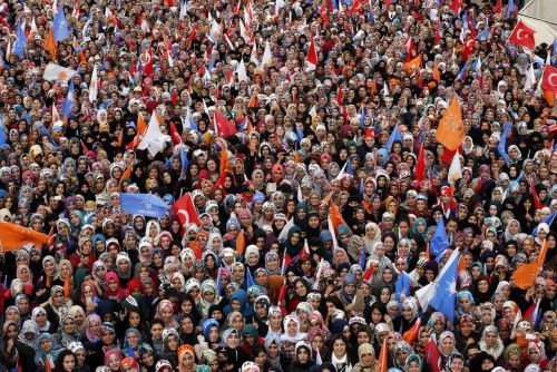 Supporters of ruling AK Party (AKP) listen as Turkey's Prime Minister Tayyip Erdogan addresses during an election rally in Elazig