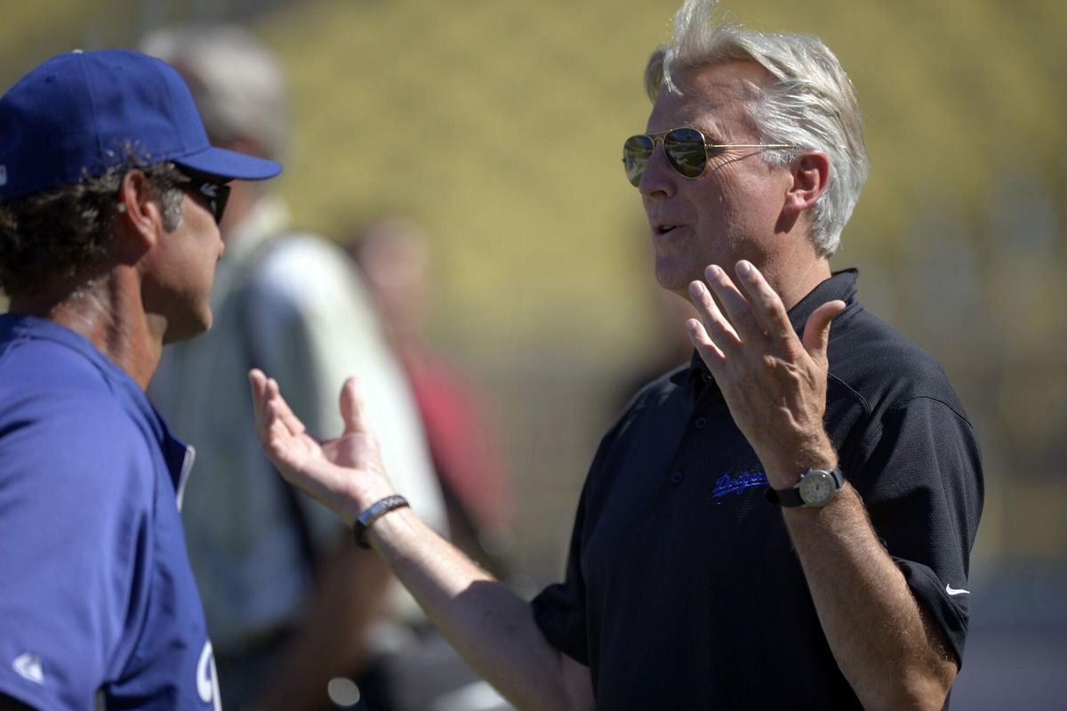 FILE - Los Angeles Dodgers co-owner Mark Walter, right, talks with manager Don Mattingly prior to their baseball game against the San Diego Padres, Sept. 3, 2012, in Los Angeles. (AP Photo/Mark J. Terrill, File). FILE PHOTO