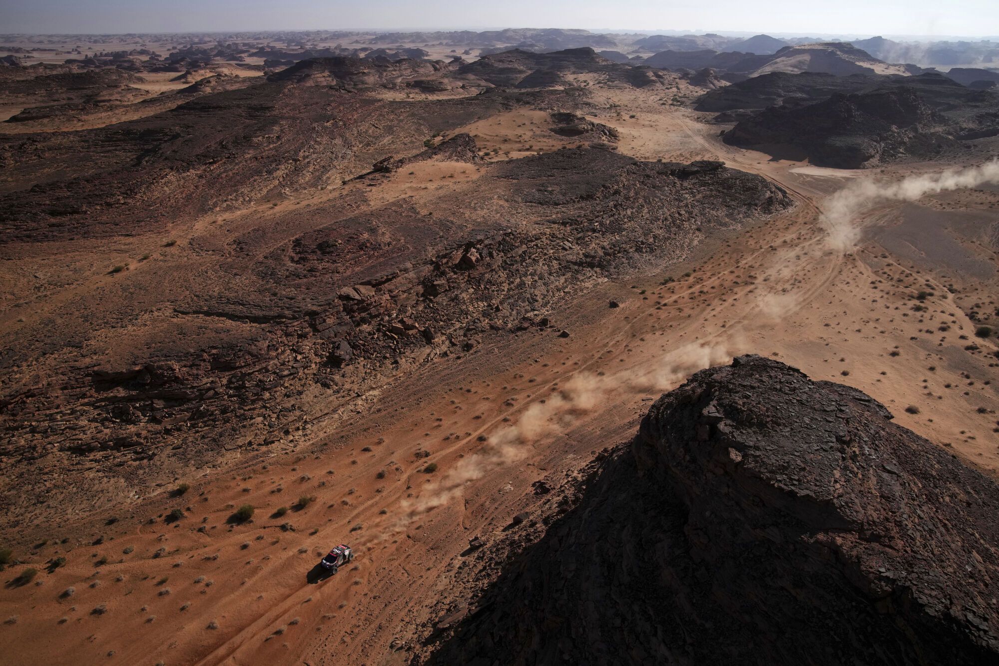 A driver competes during the fourth stage of the Dakar Rally between Al Henakiyah and Alula, Saudi Arabia, Wednesday, Jan. 8, 2025. (AP Photo/Christophe Ena)