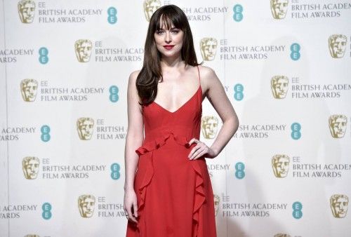 Dakota Johnson poses after presenting the award for outstanding debut  at the British Academy of Film and Television Arts (BAFTA) Awards at the Royal Opera House in London