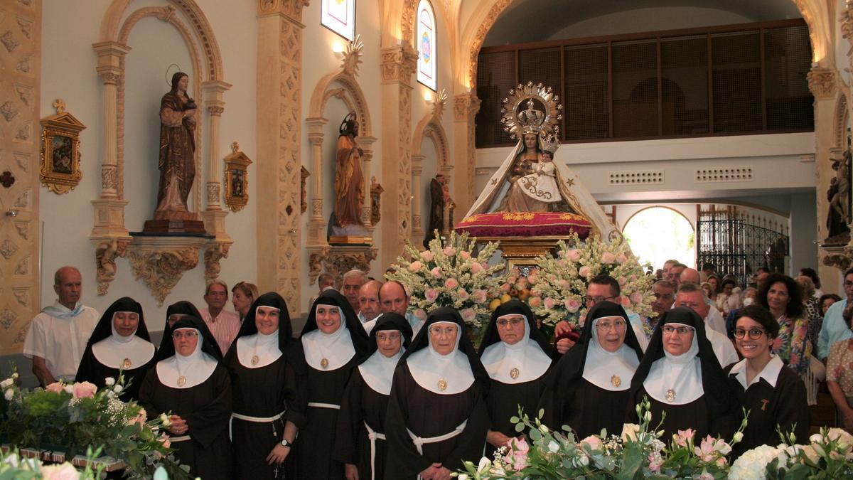 Sor Patricia, Sor Juana María, Sor María de las huertas, Sor María de los Milagros, Sor Fátima de Jesús, Madre Clara María, Sor Rosario, Sor Isabel Teresa, Sor María Jesús, Sor Ana María y la novicia Esther María, junto al trono de Santa María la Real de las Huertas en la capilla del Monasterio de Santa Ana y Santa María Magdalena de clarisas.