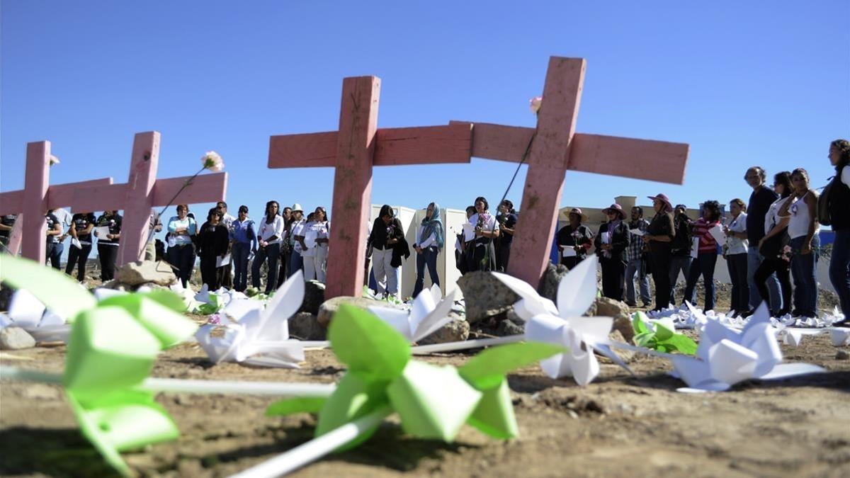 zentauroepp14462218 people stand near wooden crosses surrounded by paper flowers180615115244