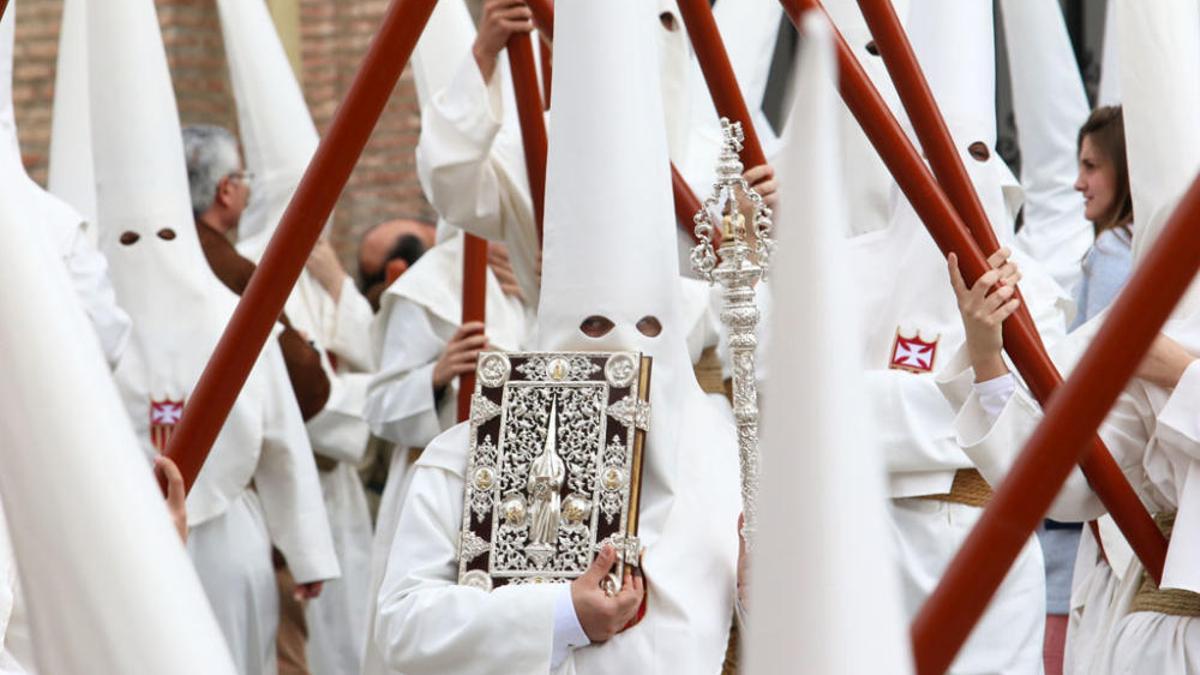 Nazarenos de la Humildad, con sus cirios al cuadril.