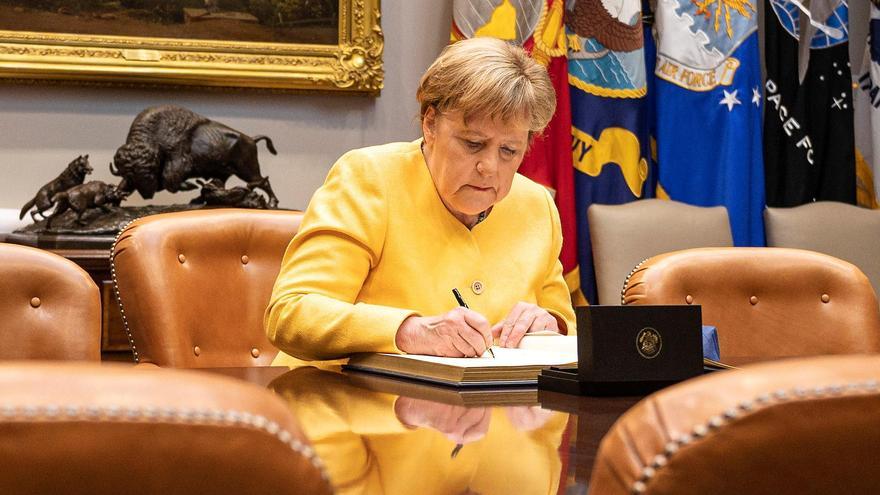 German Chancellor Merkel signs the guest book at the White House in Washington