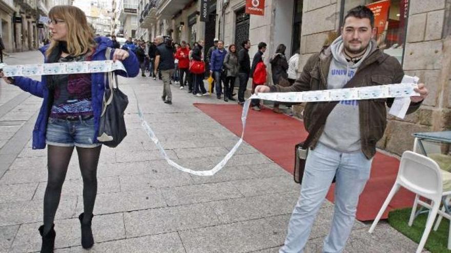 Dos aficionados muestran una tira de entradas para el clásico gallego de Riazor. // Marta G. Brea