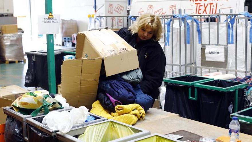 Una mujer separa las prendas que pueden ser utilizadas de las que se reciclaran o, directamente, irán al vertedero.  | JAIME GALINDO