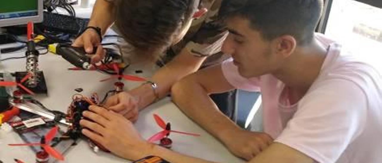 Alumnos de la Acadèmia Xúquer participan en el montaje del dron.