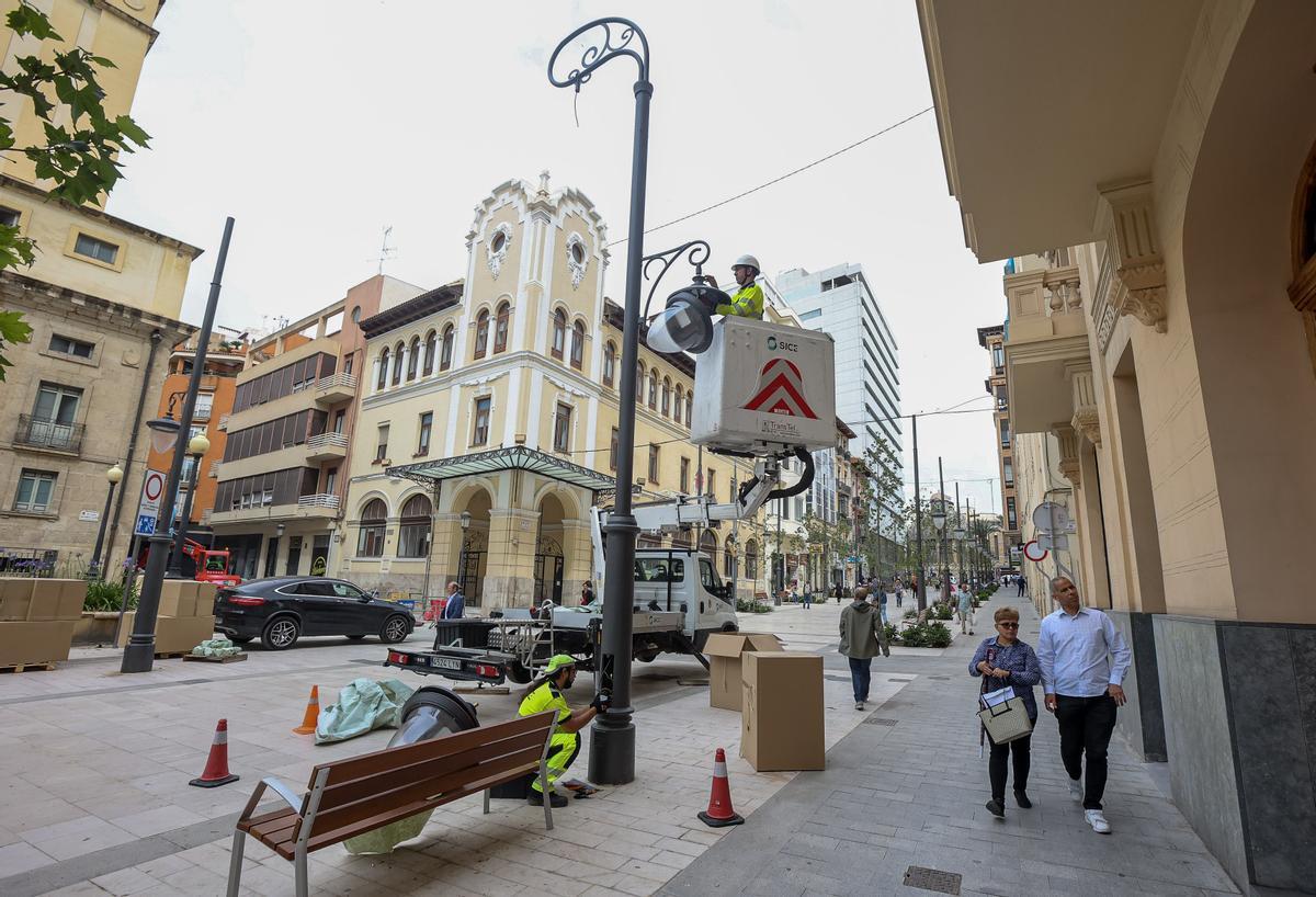 Un operario instala una de las farolas de la avenida de la Constitución.