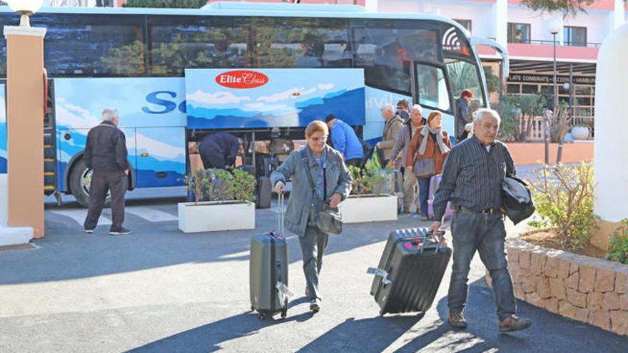 Un grupo de turistas del Imserso desembarca de un autobús y accede a su hotel en Cala de Bou el pasado mes de febrero.