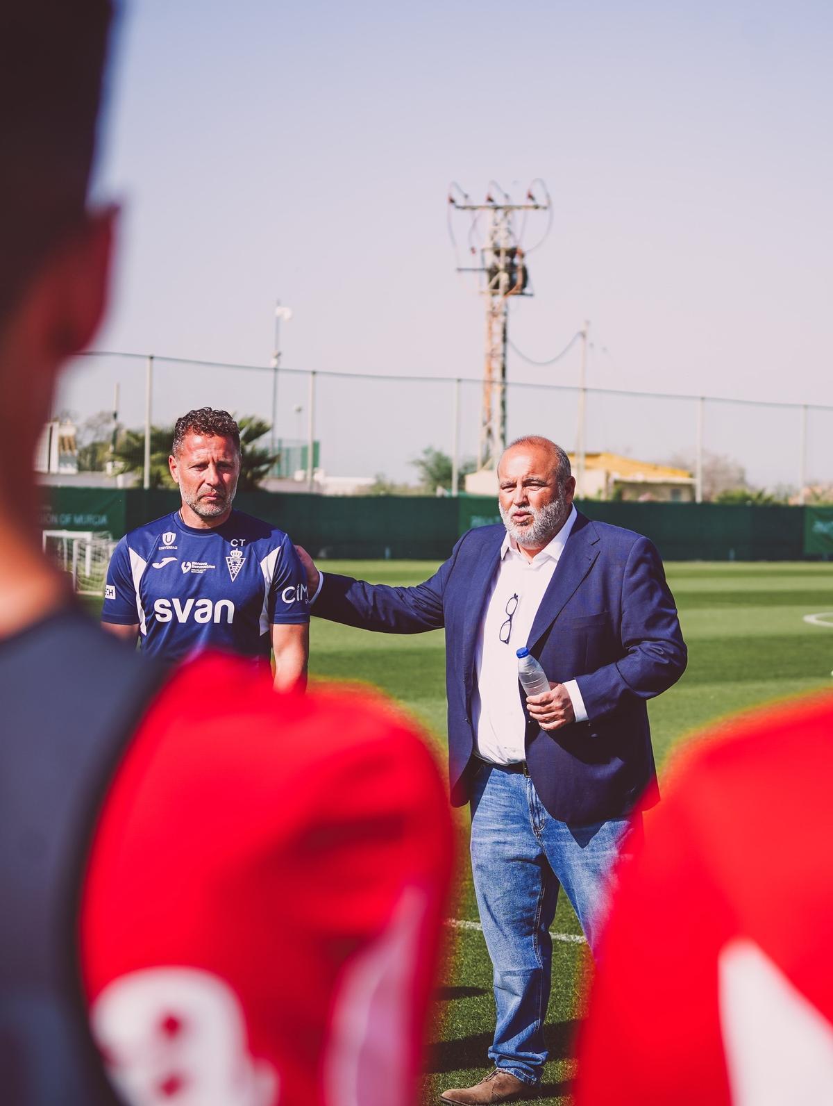 Manolo Sánchez Breis da una palmadita en la espalda de Curro Torres en su puesta de largo como director deportivo ante la plantilla