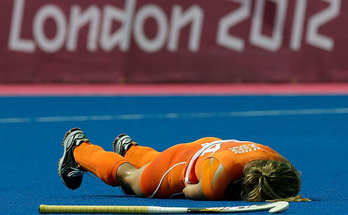 La jugadora de hockey de los Países Bajos, Eva de Goede, cae al suelo tras hacerse daño en la muñeca durante el partido contra Corea del Sur.