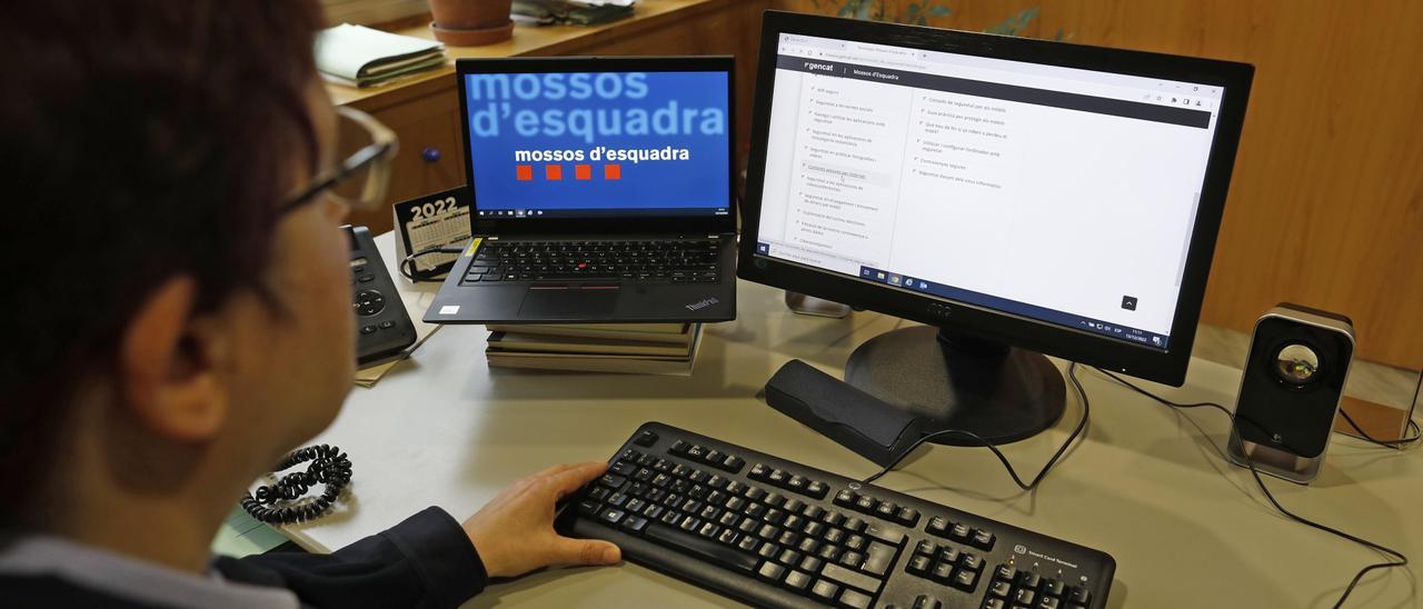 Una agent dels Mossos davant d'un ordinador i tractant un tema d'estafes.