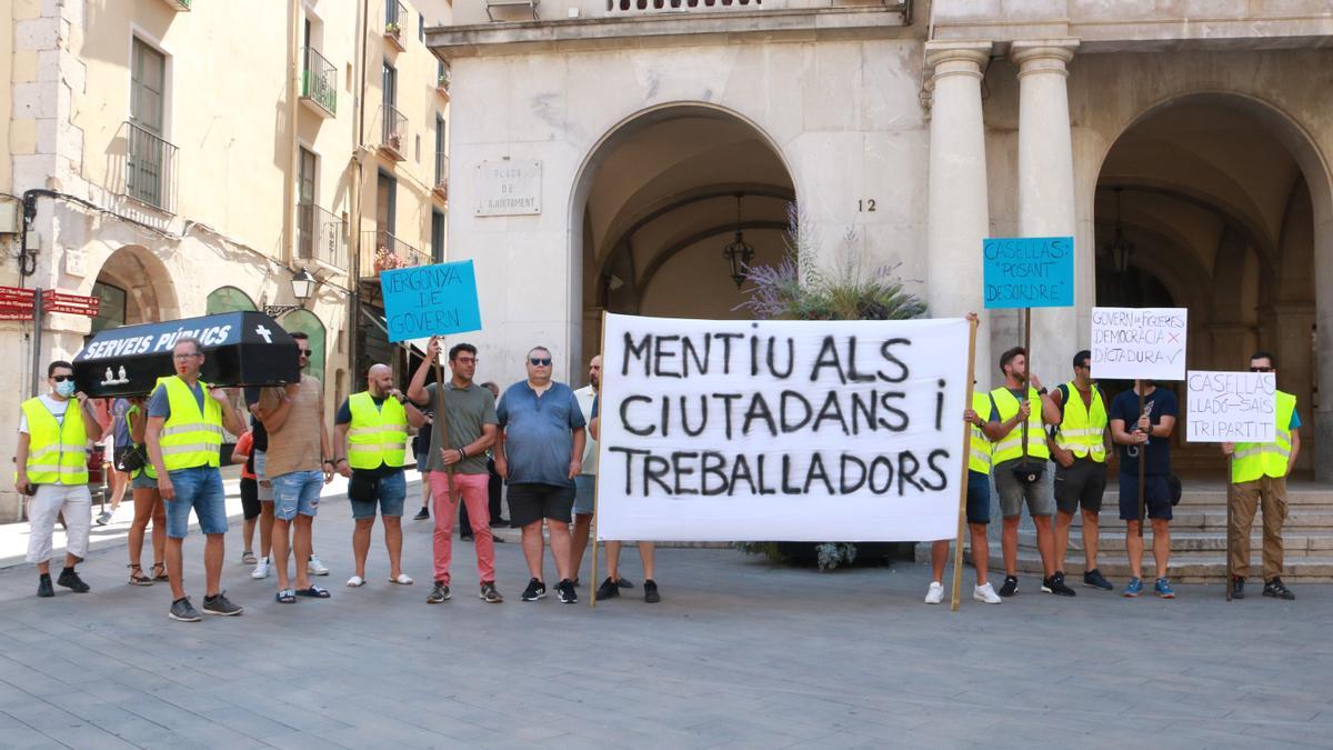Treballadors municipals porten un fèretre simulat a les portes de l'Ajuntament de Figueres com a protesta