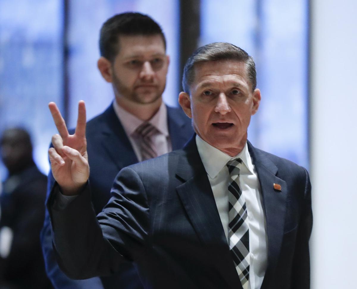 FILE- In this Nov. 17, 2016, file photo, retired Lt. Gen Michael Flynn gestures as he arrives with his son Michael G. Flynn, left, at Trump Tower in New York. Michael G. Flynn tweeted about the false idea that prompted a shooting at a Washington, D.C., pizza parlor. Vice President-elect Mike Pence acknowledged Tuesday, Dec. 6, that the younger Flynn was helping his father with scheduling and administrative items during the presidential transition but told CNN that’s no longer the case. (AP Photo/Carolyn Kaster, File)